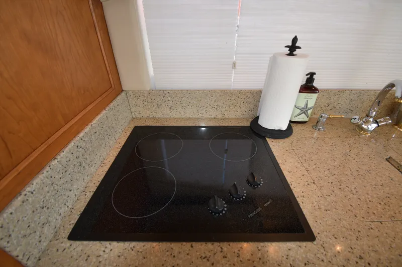 Slide: The Image of Modern kitchen cooktop in 2003 Cruisers Yachts 5000 Sedan Sport galley. - 63