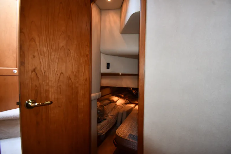 Slide: The Image of Interior cabin view of 2003 Cruisers Yachts 5000 Sedan Sport, featuring cozy sleeping quarters. - 53