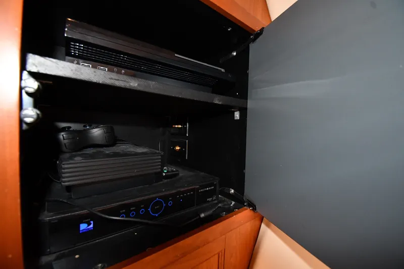 Slide: The Image of Entertainment system setup inside a cabinet on a 2003 Cruisers Yachts 5000 Sedan Sport. - 43