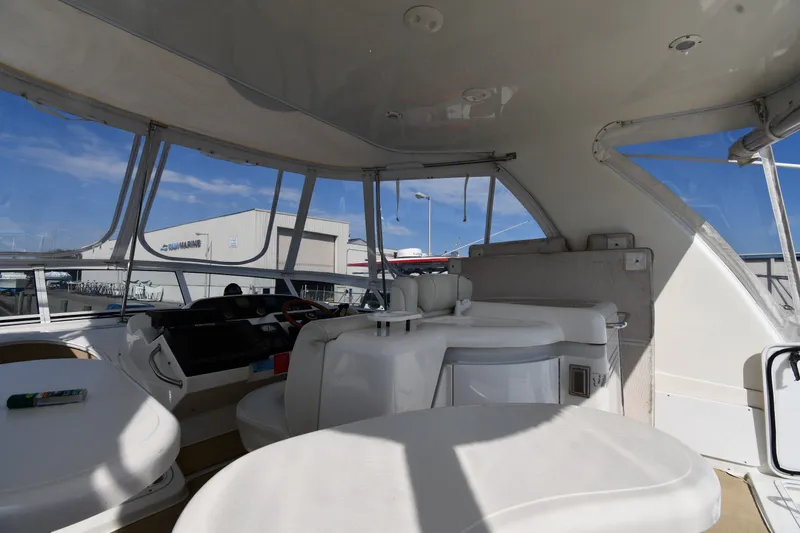Slide: The Image of Interior view of 2003 Cruisers Yachts 5000 Sedan Sport, featuring helm and seating area. - 21