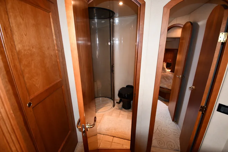 Slide: The Image of 2003 Cruisers Yachts 5000 Sedan Sport bathroom with wooden doors and modern shower. - 44
