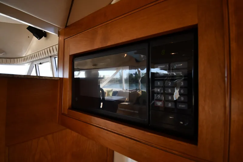 Slide: The Image of Microwave in 2003 Cruisers Yachts 5000 Sedan Sport interior, featuring wood cabinetry. - 66