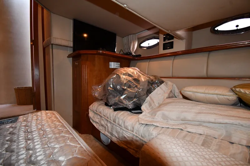 Slide: The Image of Interior cabin of 2003 Cruisers Yachts 5000 Sedan Sport with cozy bedding and TV. - 55