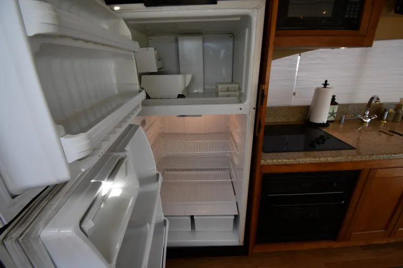 Slide: The Image of Open refrigerator in 2003 Cruisers Yachts 5000 Sedan Sport kitchen area. - 65