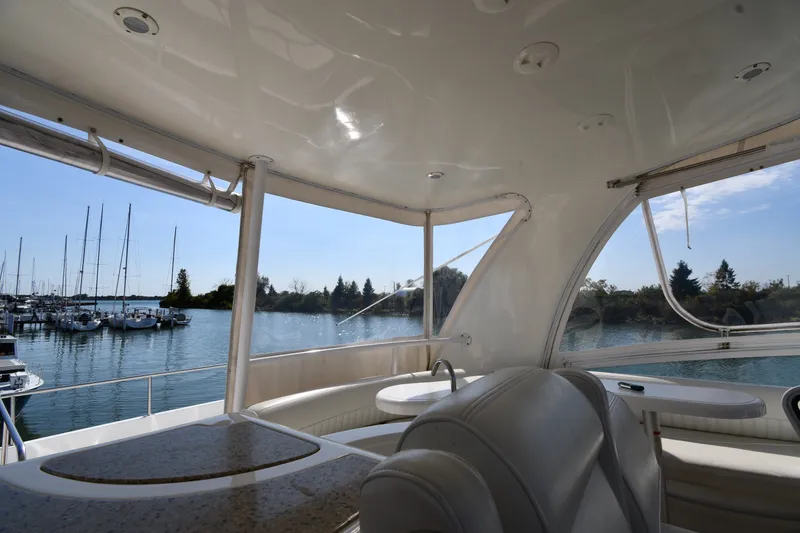 Slide: The Image of Interior view of 2003 Cruisers Yachts 5000 Sedan Sport with marina backdrop. - 29