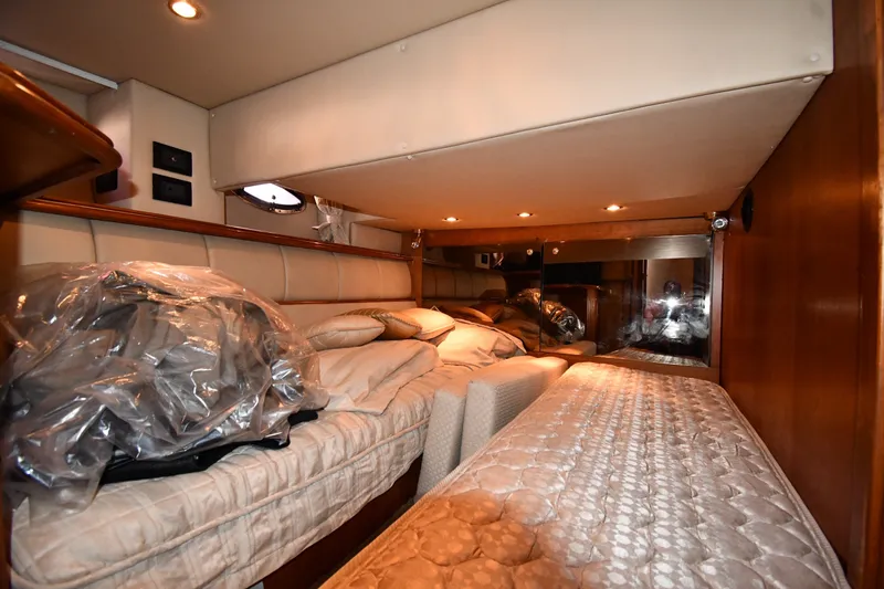 Slide: The Image of Interior cabin of 2003 Cruisers Yachts 5000 Sedan Sport with cozy bedding and ambient lighting. - 54