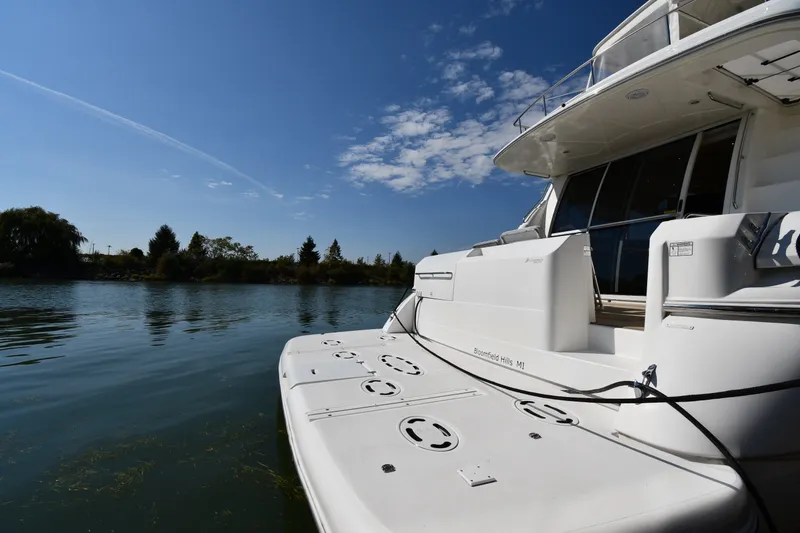 Slide: The Image of 2003 Cruisers Yachts 5000 Sedan Sport docked on a sunny day. - 7