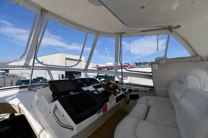 Slide: The Image of Interior view of 2003 Cruisers Yachts 5000 Sedan Sport helm with modern navigation equipment. - 23