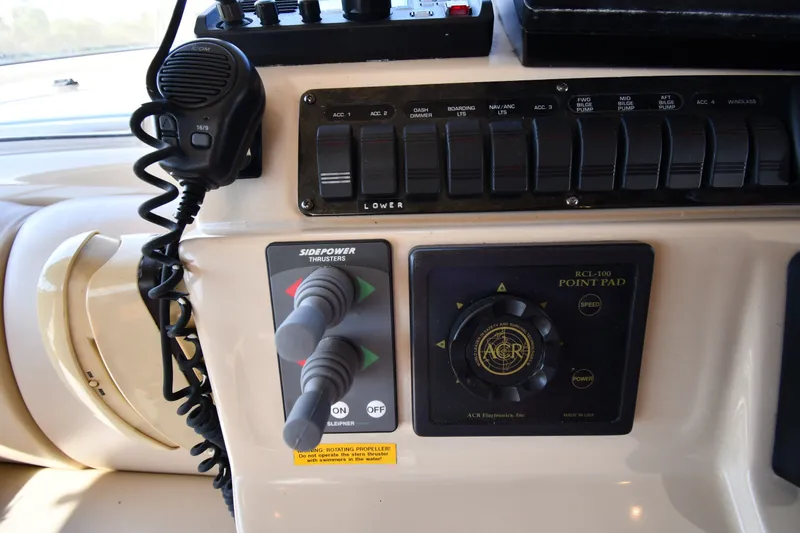 Slide: The Image of Control panel of a 2003 Cruisers Yachts 5000 Sedan Sport with thruster controls and microphone. - 71