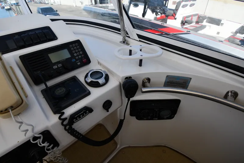 Slide: The Image of Control panel of a 2003 Cruisers Yachts 5000 Sedan Sport, featuring navigation and communication equipment. - 27