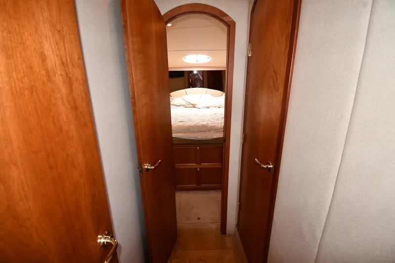 Slide: The Image of 2003 Cruisers Yachts 5000 Sedan Sport interior hallway leading to a cozy bedroom. - 36