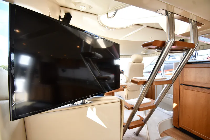 Slide: The Image of Interior of 2003 Cruisers Yachts 5000 Sedan Sport with TV and modern staircase. - 77