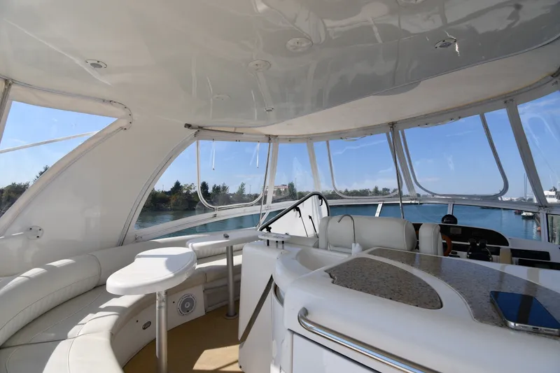 Slide: The Image of Interior view of 2003 Cruisers Yachts 5000 Sedan Sport, featuring spacious seating and panoramic windows. - 22