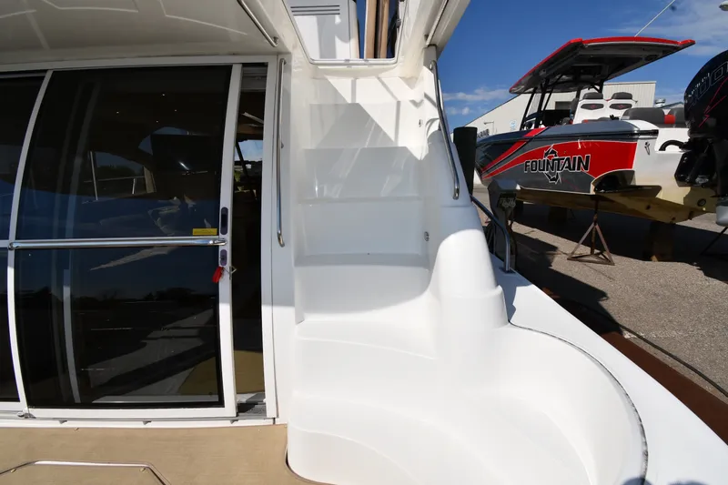 Slide: The Image of 2003 Cruisers Yachts 5000 Sedan Sport with sleek white exterior and sliding glass door. - 18