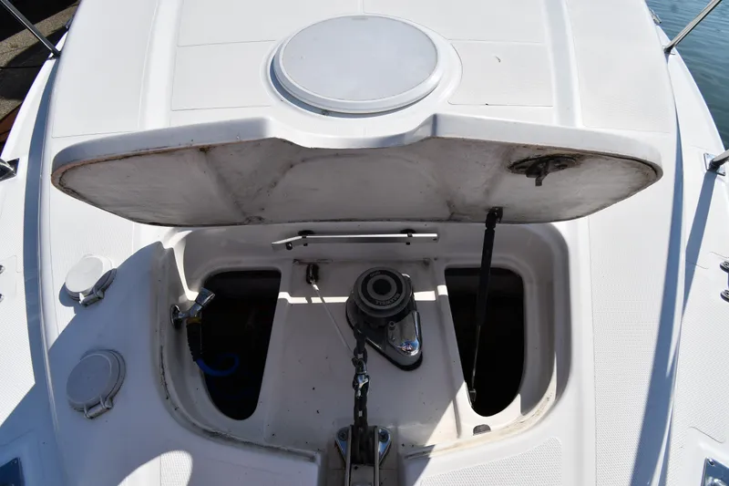 Slide: The Image of Open hatch on 2003 Cruisers Yachts 5000 Sedan Sport, revealing anchor mechanism. - 9
