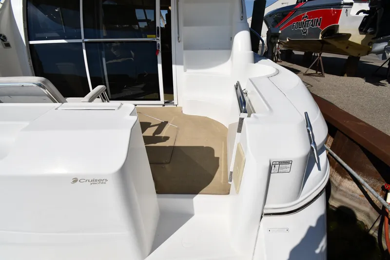 Slide: The Image of 2003 Cruisers Yachts 5000 Sedan Sport, rear deck view with seating and entryway. - 13
