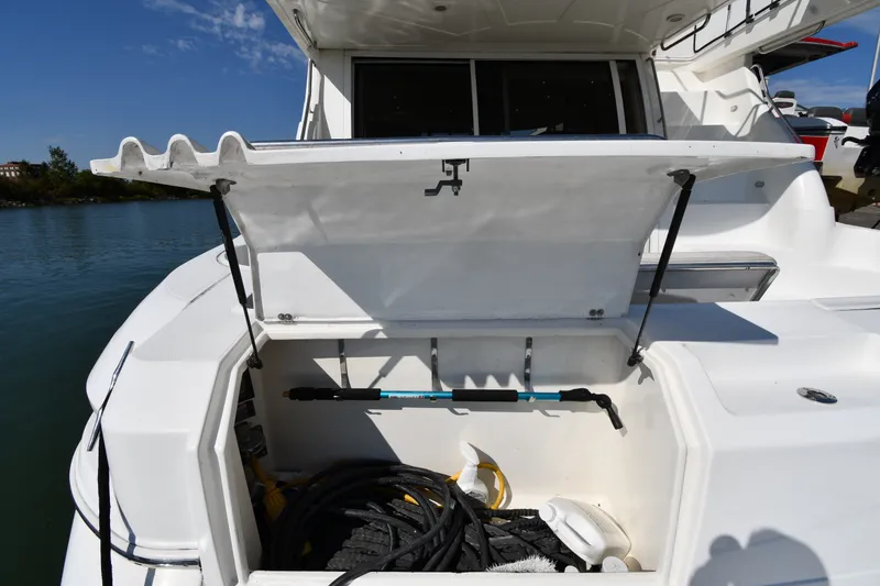 Slide: The Image of Open storage compartment on 2003 Cruisers Yachts 5000 Sedan Sport, featuring marine equipment. - 19