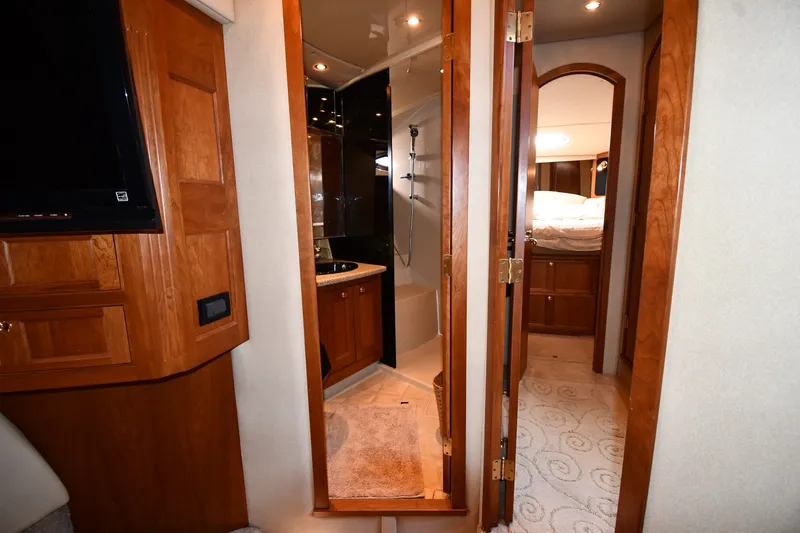 Slide: The Image of Interior of 2003 Cruisers Yachts 5000 Sedan Sport, featuring wood cabinetry and cozy bedroom. - 51