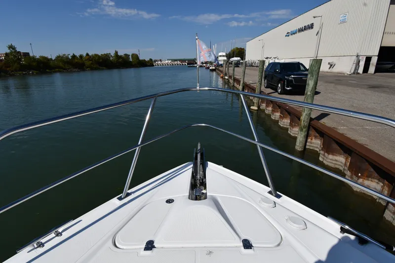 Slide: The Image of 2003 Cruisers Yachts 5000 Sedan Sport docked at marina, calm water, clear sky. - 8