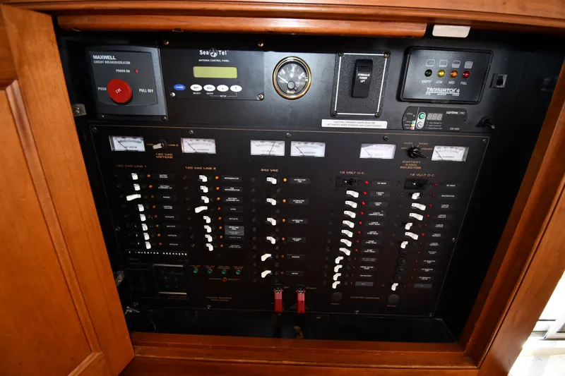 Slide: The Image of Electrical control panel of 2003 Cruisers Yachts 5000 Sedan Sport, featuring various switches and meters. - 78