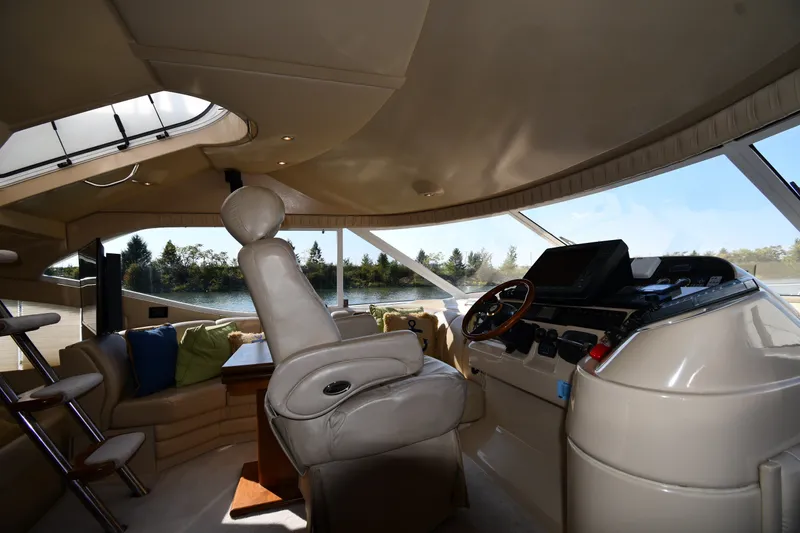 Slide: The Image of Luxurious interior of 2003 Cruisers Yachts 5000 Sedan Sport with helm and seating area. - 68