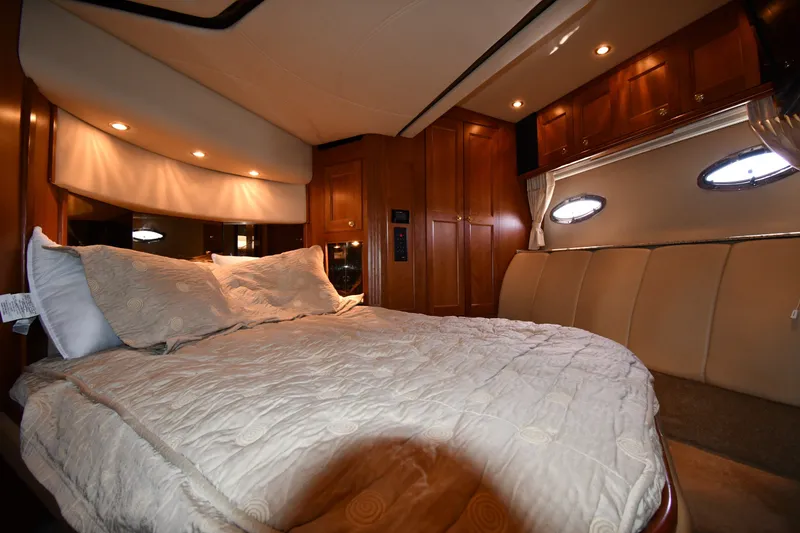 Slide: The Image of Luxurious bedroom interior of 2003 Cruisers Yachts 5000 Sedan Sport with elegant wood finishes. - 50