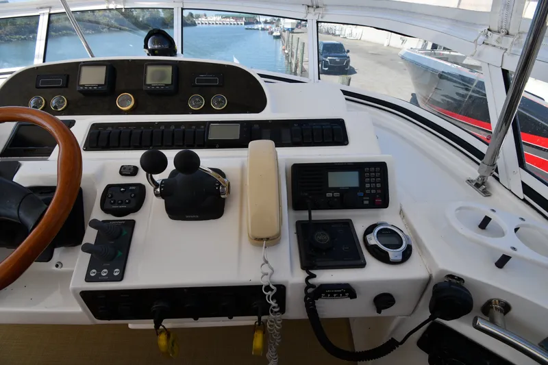 Slide: The Image of Cockpit of 2003 Cruisers Yachts 5000 Sedan Sport with navigation controls and steering wheel. - 26