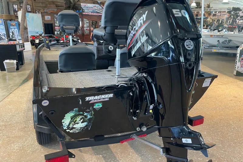 Slide: The Image of 2024 Tracker Pro 170 boat with Mercury 50 engine displayed indoors. - 14