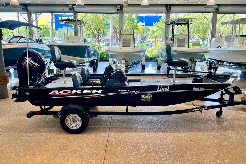 The Image of 2024 Tracker Pro 170 fishing boat displayed in a showroom with other boats. - 0
