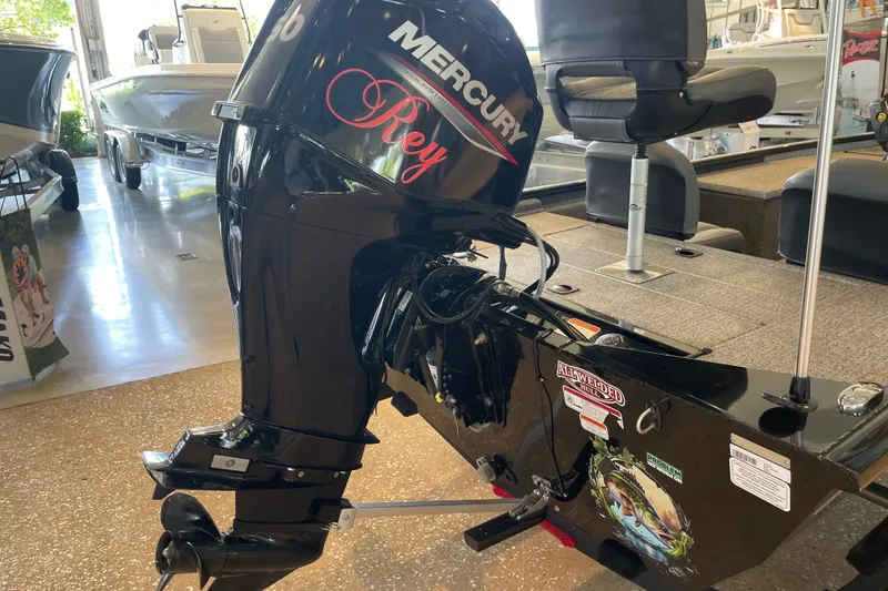 Slide: The Image of 2024 Tracker Pro 170 boat with Mercury outboard motor in showroom. - 13