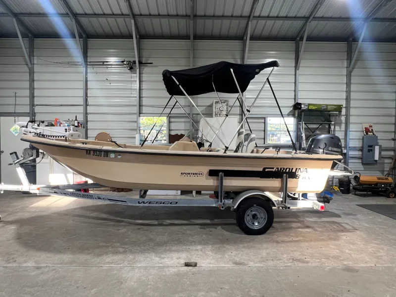 The Image of 2008 Carolina Skiff JVX18SS on a trailer inside a warehouse. - 0