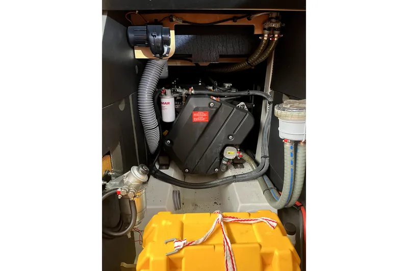 Slide: The Image of Engine compartment of 2016 Jeanneau Sun Odyssey 469 sailboat, showcasing mechanical components and wiring. - 17