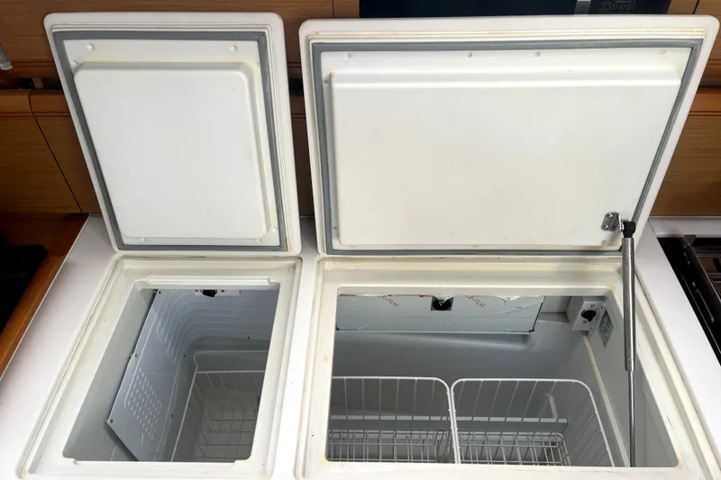 Slide: The Image of Open dual-compartment refrigerator on a 2016 Jeanneau Sun Odyssey 469 yacht. - 15