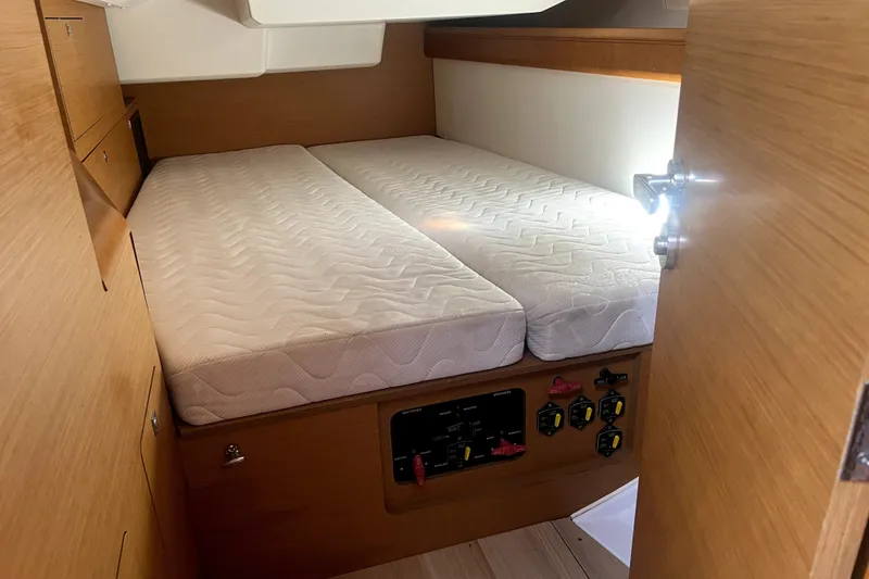Slide: The Image of Cabin interior of 2016 Jeanneau Sun Odyssey 469 with twin mattresses and control panel. - 14