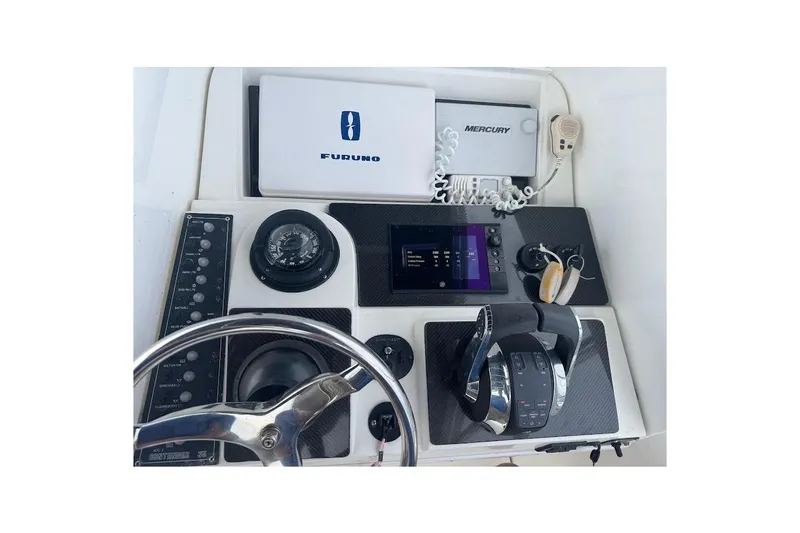 Slide: The Image of Control panel of a 2001 Contender 35 Side Console boat with navigation equipment. - 24