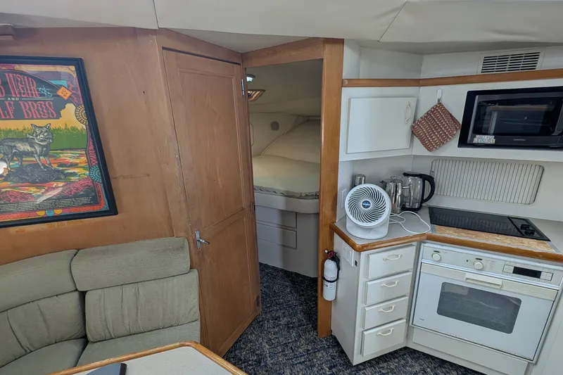 Slide: The Image of Interior of 1994 Carver 370 Aft Cabin Motor Yacht with kitchenette and cozy seating area. - 35