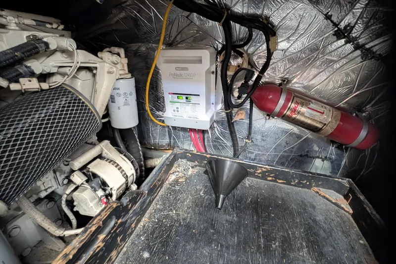Slide: The Image of Engine room of 1994 Carver 370 Aft Cabin Motor Yacht with fire extinguisher and battery charger. - 52