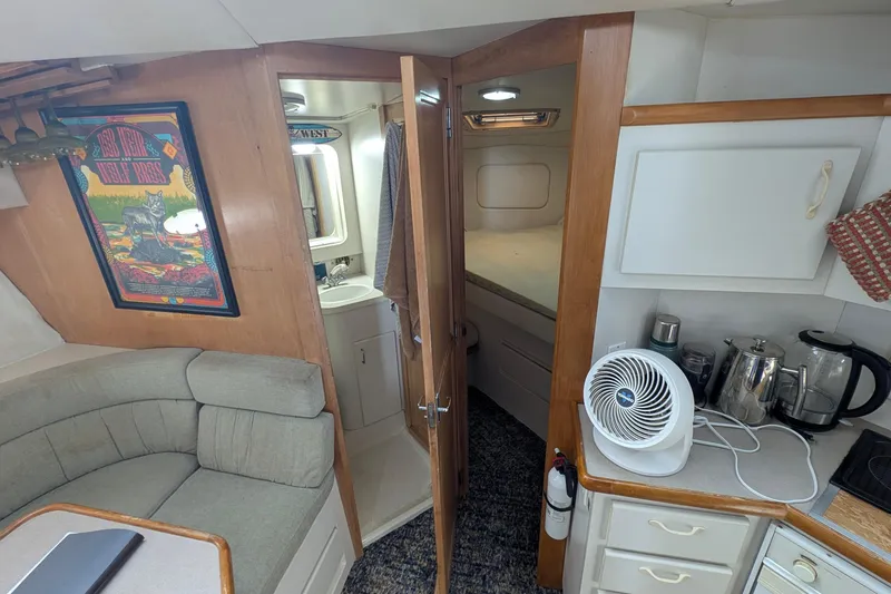 Slide: The Image of Interior of 1994 Carver 370 Aft Cabin Motor Yacht with kitchenette and seating area. - 34