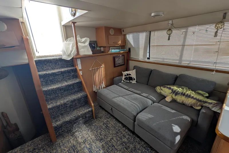 Slide: The Image of Interior of 1994 Carver 370 Aft Cabin Motor Yacht with cozy seating and decor. - 23