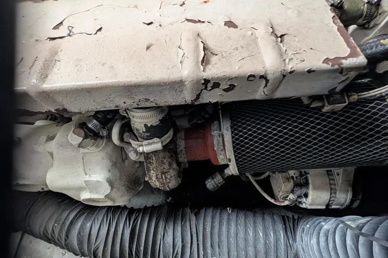 Slide: The Image of Engine compartment of a 1994 Carver 370 Aft Cabin Motor Yacht, showing wear and components. - 54