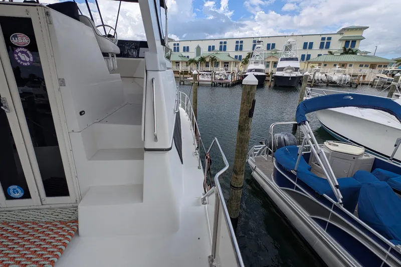 Slide: The Image of 1994 Carver 370 Aft Cabin Motor Yacht docked at marina with other boats. - 15