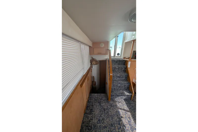 Slide: The Image of Interior view of 1994 Carver 370 Aft Cabin Motor Yacht with carpeted stairs and window blinds. - 41