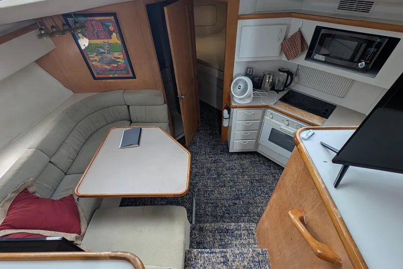 Slide: The Image of Interior of 1994 Carver 370 Aft Cabin Motor Yacht with kitchen and seating area. - 28