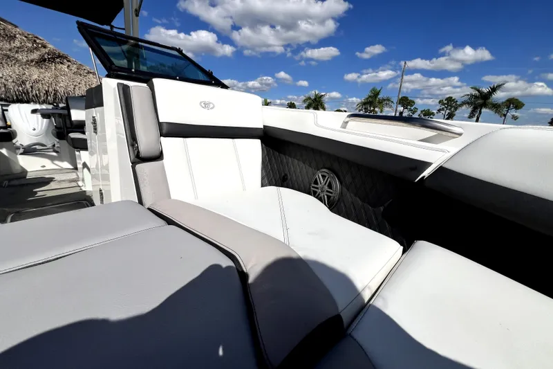 Slide: The Image of 2022 Cobalt R6 Outboard boat interior with luxurious seating under a clear blue sky. - 84