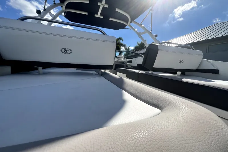 Slide: The Image of 2022 Cobalt R6 Outboard boat interior with white seating under sunny sky. - 60