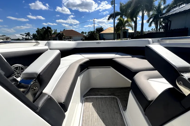 Slide: The Image of 2022 Cobalt R6 Outboard boat interior with luxurious seating under a sunny sky. - 82