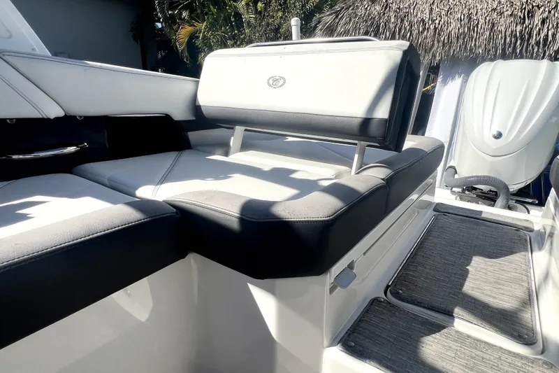 Slide: The Image of 2022 Cobalt R6 Outboard boat interior with cushioned seating and outboard motor. - 62