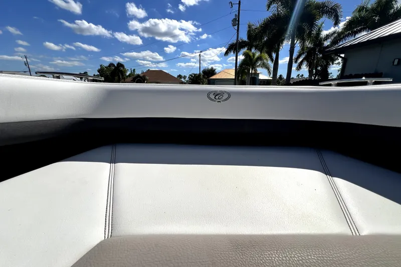 Slide: The Image of 2022 Cobalt R6 Outboard boat interior with white seating under a sunny sky. - 86