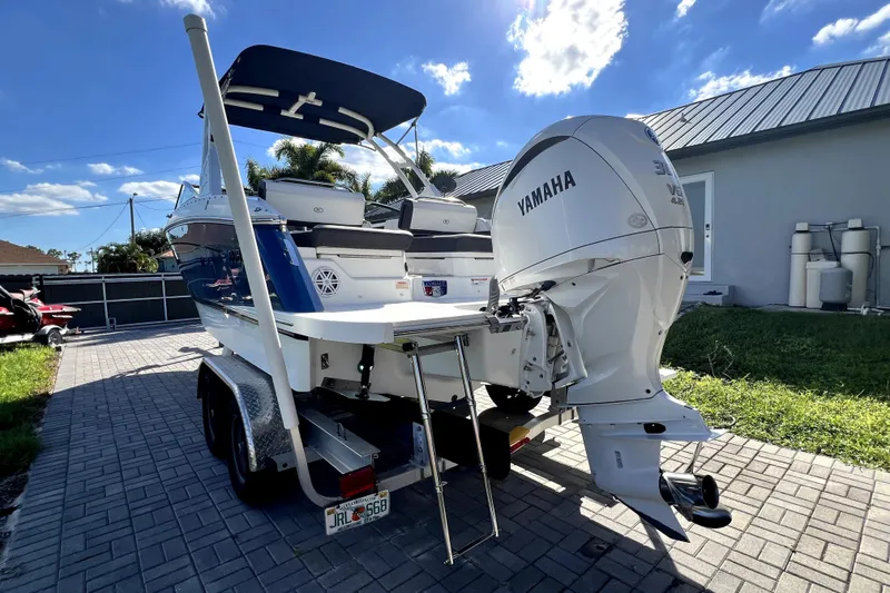 Slide: The Image of 2022 Cobalt R6 Outboard boat with Yamaha engine on a trailer, parked outdoors. - 16