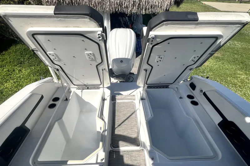 Slide: The Image of 2022 Cobalt R6 Outboard boat with open storage compartments and visible engine. - 61